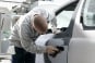 Auto-Body Shop Worker Sands a Car Door