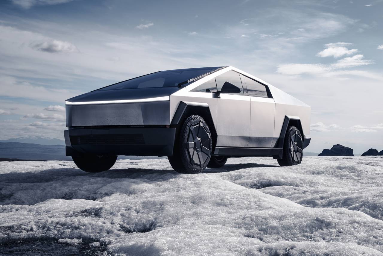 Electric SUV driving along a mountain road at golden hour